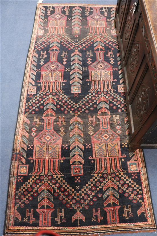 A Belouchi red and black ground rug, 7ft by 2ft 11in.